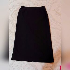 LeSuit below the knee, split in the back, no pockets skirt.